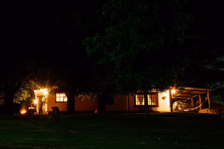 Las Moras de noche, con las ventanas encendidas entre los árboles